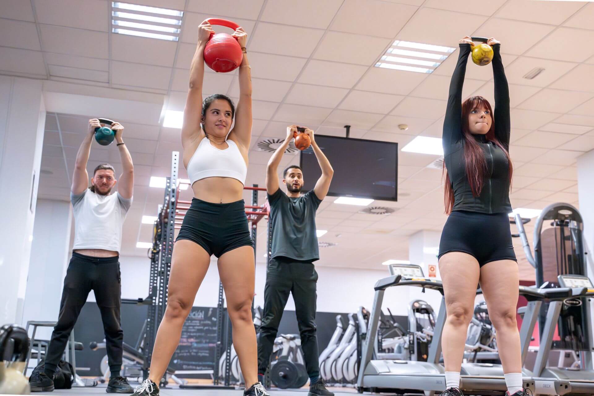 gym class performing overhead kettlebell lifts in 2024 12 05 11 37 20 utc